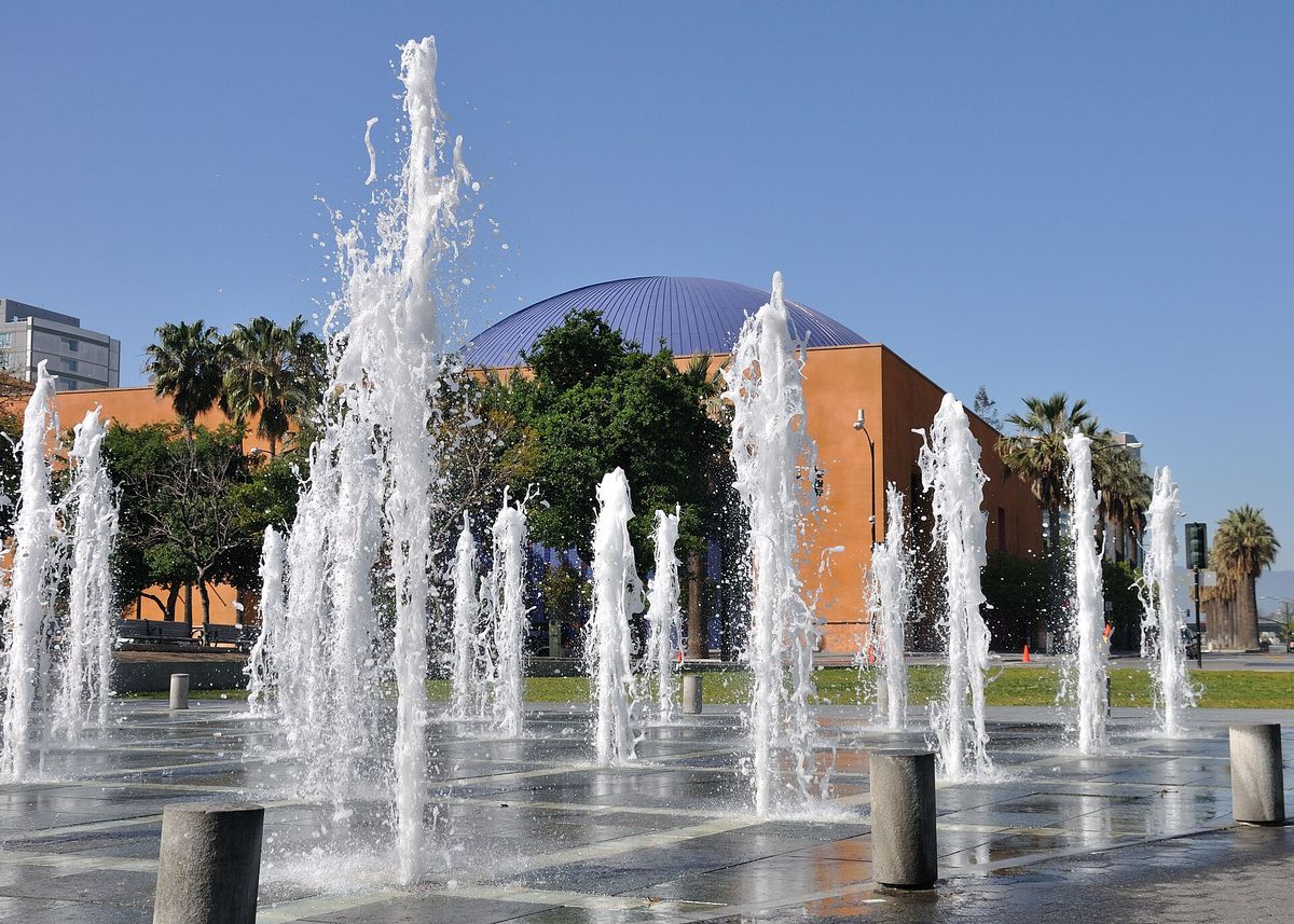 Lawns, palms and fountain jets in the downtown plaza